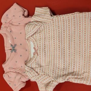 A pair of newborn onesies